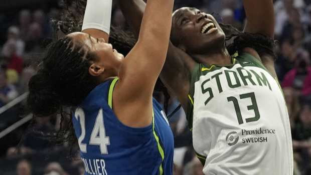 May 27, 2025; Minneapolis, Minnesota, USA; Seattle Storm forward Ezi Magbegor (13) goes to the basket against Minnesota Lynx forward Napheesa Collier (24) in the first quarter at Target Center.