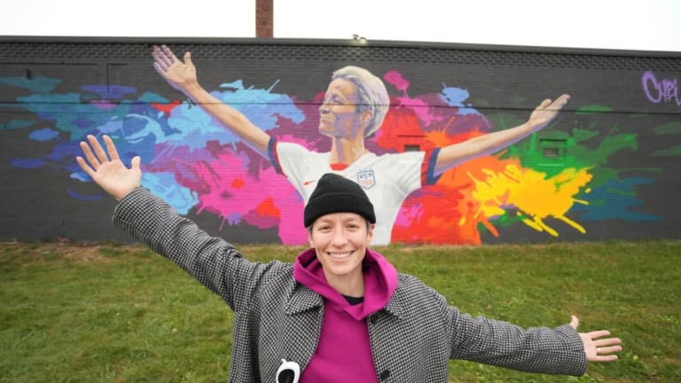 U.S. Women's National Team hero Megan Rapinoe signs her mural at St. Paul bar