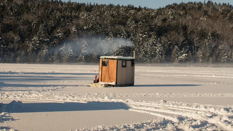 An ice fishing house, a propane heater and biting perch Stock Photo - Alamy