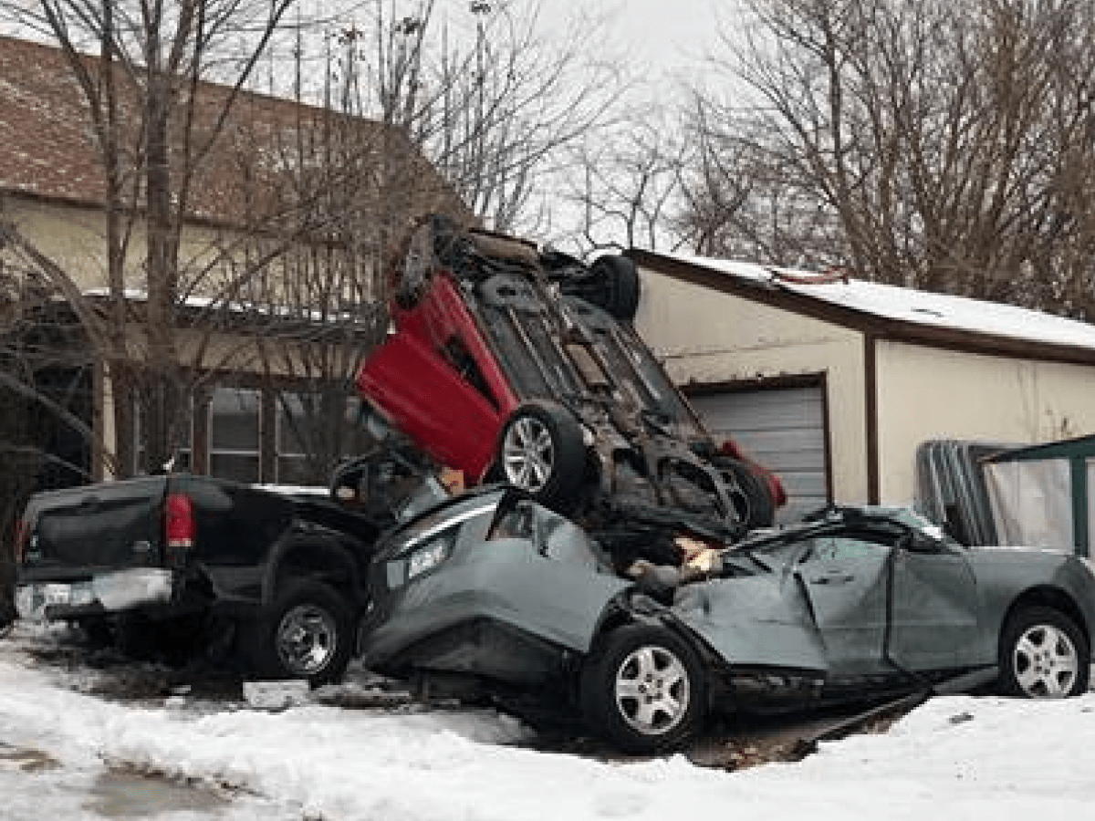 Car goes airborne crashes on top of parked vehicles outside