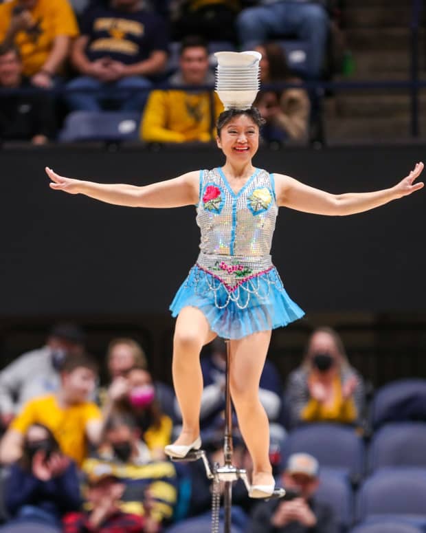 Jan 18, 2022; Morgantown, West Virginia, USA; Acrobat and performer Krystal Niu, known as Red Panda, performs at halftime at WVU Coliseum.