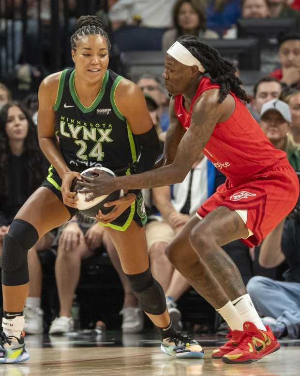 Jul 1, 2025; Minneapolis, Minnesota, USA; Minnesota Lynx forward Napheesa Collier (24) backs towards the basket against Indiana Fever forward Natasha Howard (6) in the first half during the Commissioner's Cup final at Target Center.