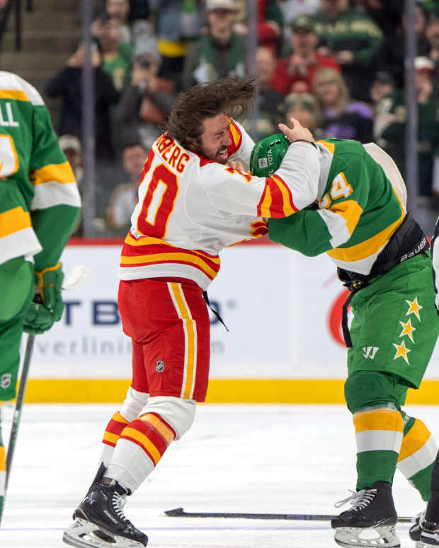 Calgary Flames left wing Ryan Lomberg (70) fights with Minnesota Wild center Jakub Lauko (94) in the second period at Xcel Energy Center in St. Paul, Minn., on Jan. 25, 2025.