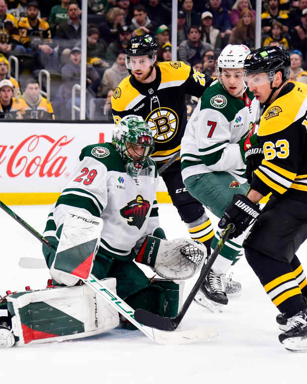 Feb 4, 2025; Boston, Massachusetts, USA; Boston Bruins left wing Brad Marchand (63) looks for a rebound in front of Minnesota Wild goaltender Marc-Andre Fleury (29) during the first period at TD Garden. Mandatory Credit: Bob DeChiara-Imagn Images  