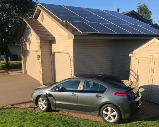 Electric Vehicle with Solar Panel Charger Garage