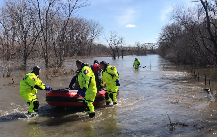 Walker rescued after being swept away on flooded trail in Bloomington ...