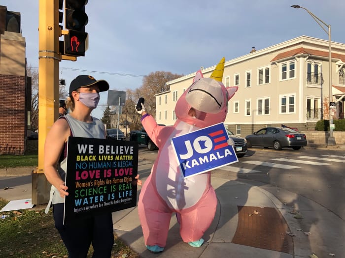 Melissa Schuler and Sunny Kase, who first met while demonstrating at the same intersection on Tuesday, hang out and celebrate Joe Biden's win Saturday.