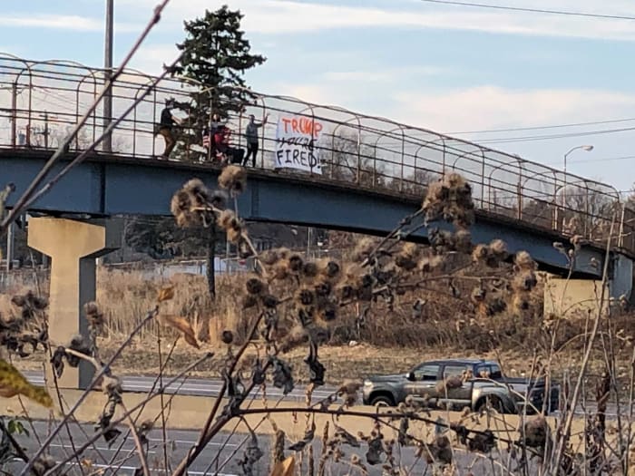 A group of friends demonstrating Saturday afternoon over I-94 in St. Paul after president Donald Trump lost his seat to Joe Biden.