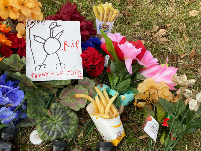 Flowers, battery operated candles, cards and french fries adorned Penny's memorial in Bloomington Thursday afternoon.