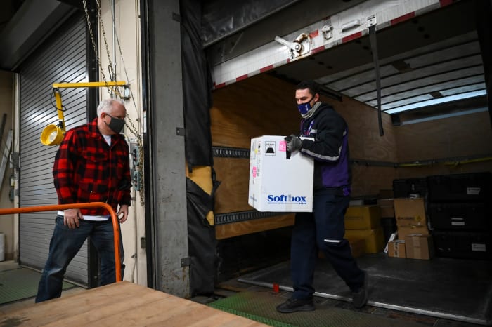 Gov. Tim Walz looks on as the first shipments of the COVID-19 vaccine arrive in Minnesota Monday morning.