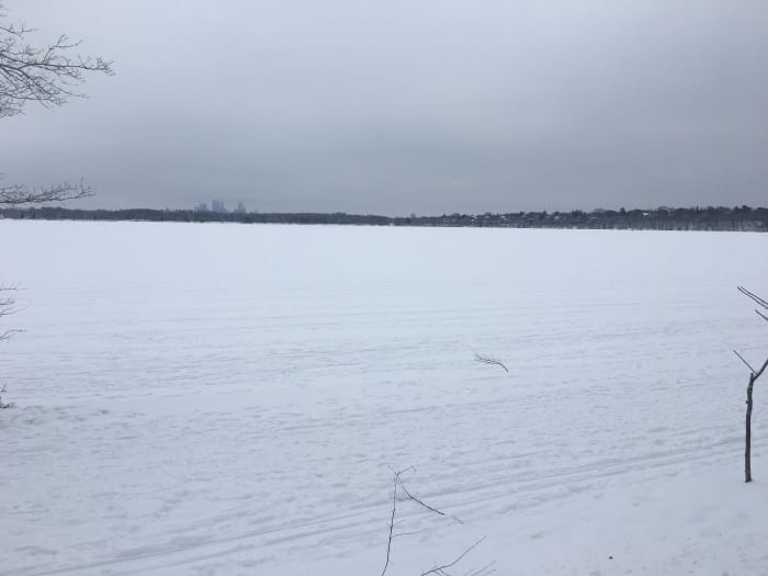 Lake Harriet covered in snow Thursday. While it appears to be mostly frozen over, snow can make it more difficult to visually gauge thickness of ice. Lakes can have patches of safe and unsafe ice close together.