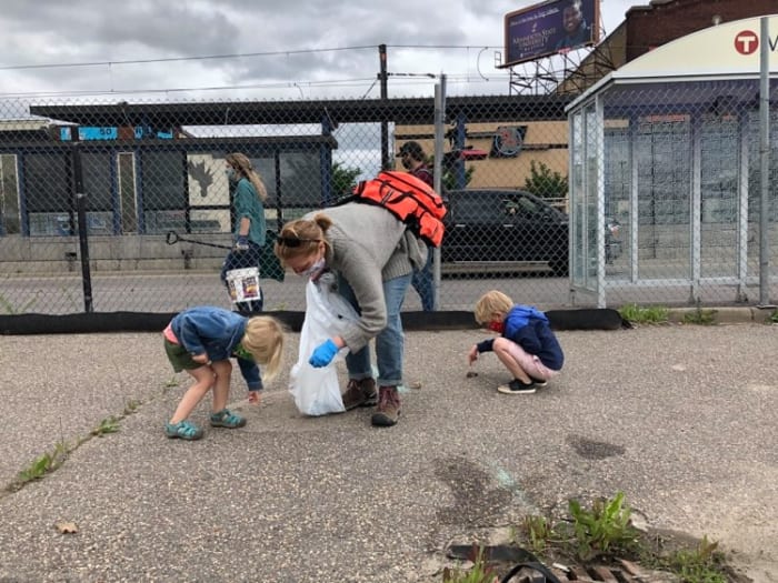 Longtime St. Paul resident Angela Elder Woodbury came to clean debris left by riots in Midway with her 5- and 3-year-old. “It’s a good way to learn how to help when they can,” she said.