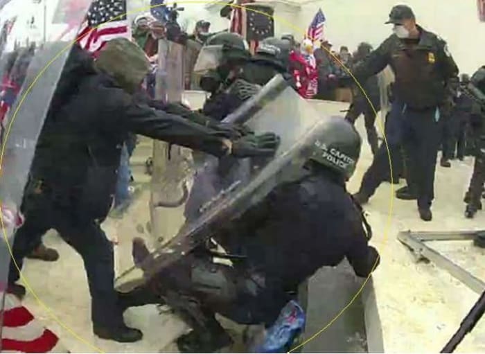 A screengrab from body camera footage, purportedly showing Brian Mock shoving a Capitol police officer to the ground.