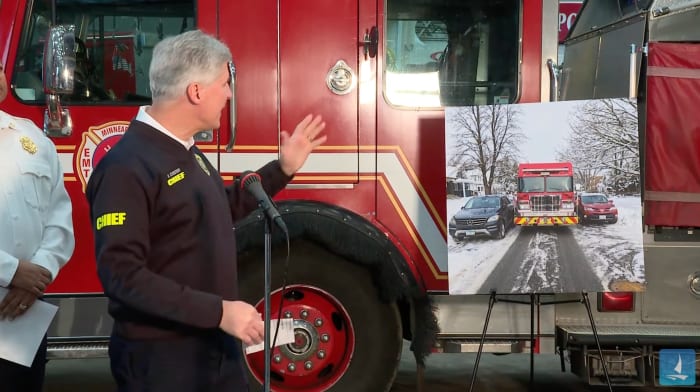 Hennepin County EMS Chief Martin Scheerer references a photo of a firetruck navigating a side street in Minneapolis during a press conference on Jan. 25, 2023.