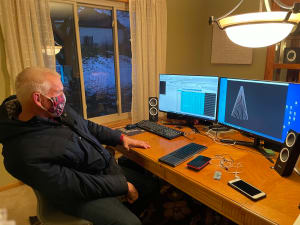 Mike Justak sitting at his dining room table in 2020, where he designs his light show.