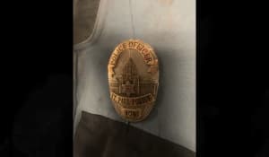 A photo from the St. Paul Police Department shows blood on Officer Michael Ganzel's badge.