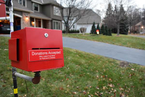 A donation box in Justak's yard. He's raised more than $100,000 for his foundation through his light show.