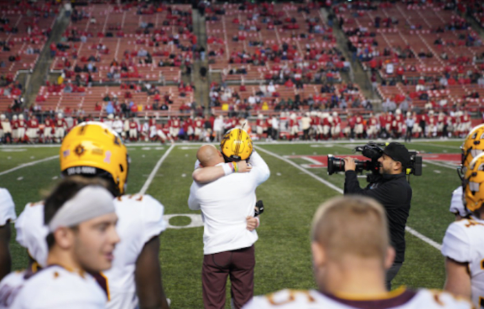 Casey O'Brien and P.J. Fleck embrace after O'Brien made his college football debut at Rutgers.
