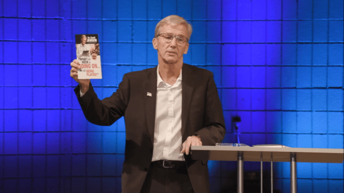 Dr. Scott Jensen, displaying a promotion for his upcoming book during the Sept. 25 conference.