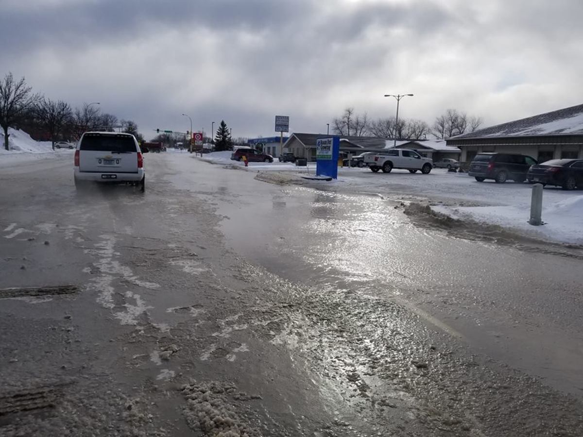 Flooded roads from a water main break in Forest Lake on Tuesday. 