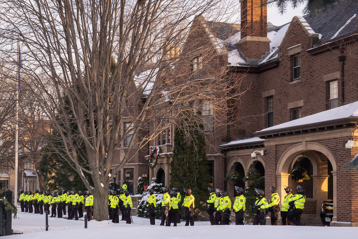 Law enforcement stands outside the governor's residence in St. Paul on Jan. 6.