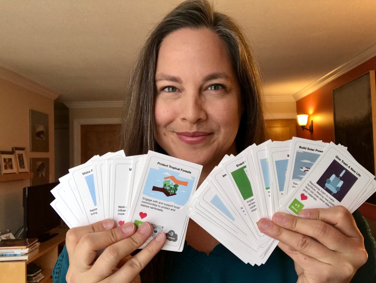 Alix Dvorak, holding some of the cards from an earlier prototype of the game.