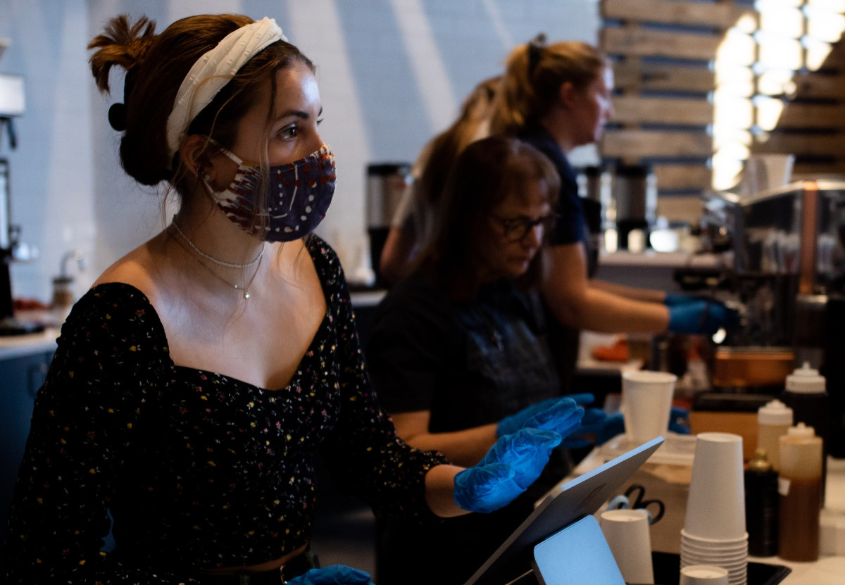unsplash restaurant cashier register COVID face mask - crop