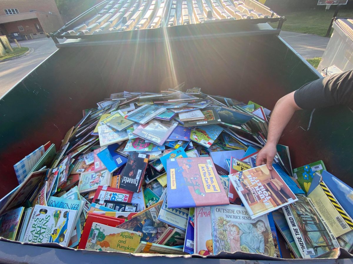 Bewilderment at dumpster full of kid's books outside Minneapolis' Bryn