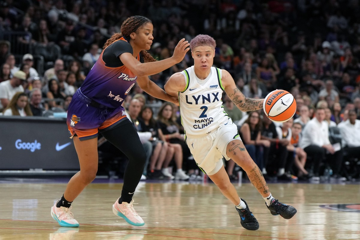 May 30, 2025; Phoenix, Arizona, USA; Minnesota Lynx guard Natisha Hiedeman (2) drives around Phoenix Mercury guard Monique Akoa Makani (8) in the second half at Footprint Center.